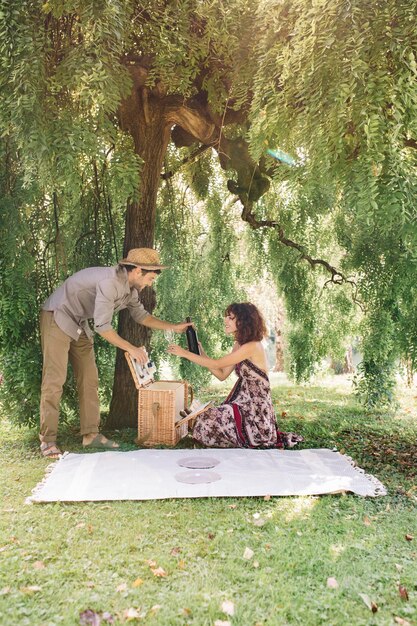 Casal preparando um piquenique em um parque