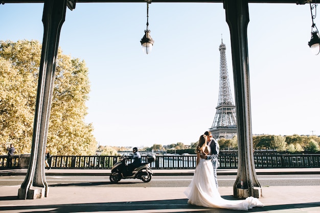 Casal romântico feliz abraçando perto da torre Eiffel em Paris