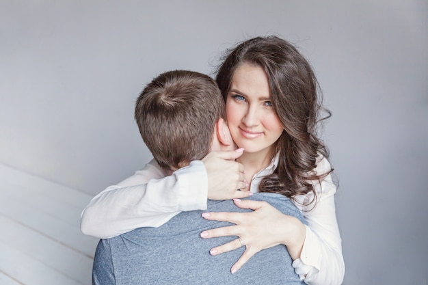 Casal romântico sexy apaixonado, tendo um bom tempo juntos. jovem mulher abraçando o namorado, fundo branco