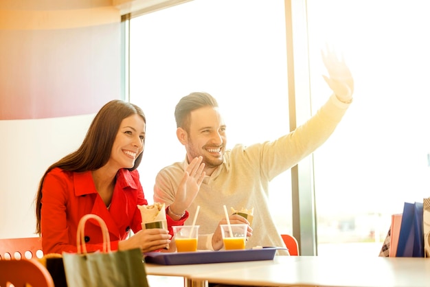 Foto casal se divertindo no restaurante de fast food