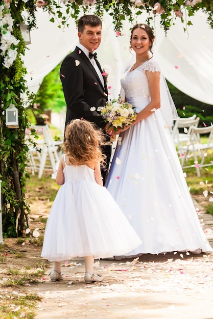 Casamento voando pétalas de rosa de crianças na cerimônia