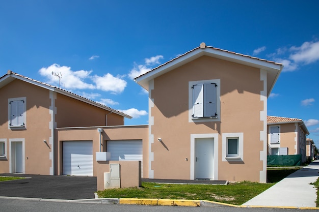 Casas adosadas nuevas recientes de una sola planta en una subdivisión de casas adosadas junto a la fachada del garaje.