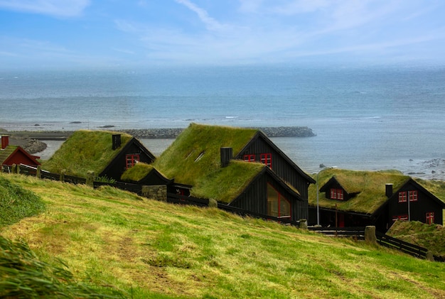 Casas de madeira tradicionais com telhados de grama nas Ilhas Faroé