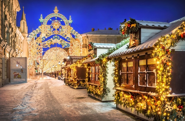 Casas y decoraciones de Año Nuevo en la calle Nikolskaya en Moscú en una nevada noche de invierno