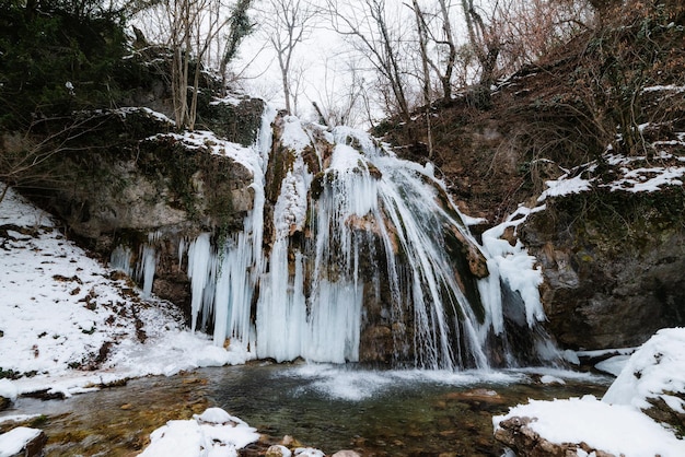 Foto cascada en el bosque de invierno