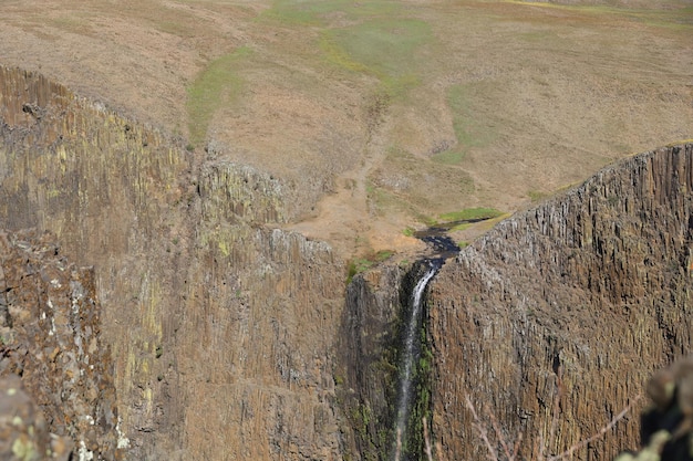 una cascada está en el medio de un gran acantilado