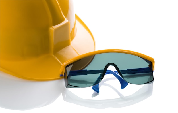 Foto casco amarillo y gafas de seguridad azules.