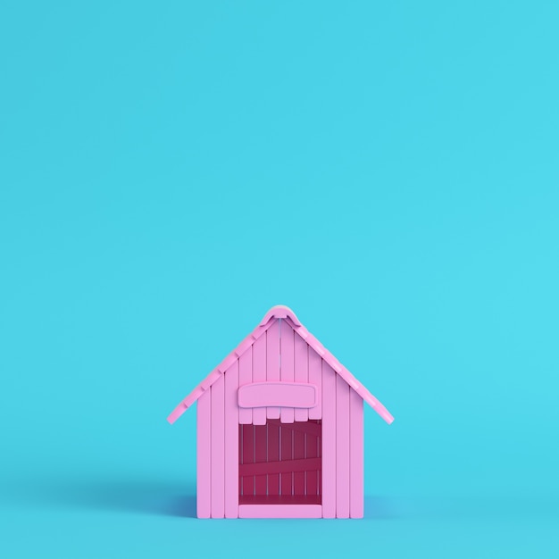 Caseta de perro rosa sobre fondo azul brillante