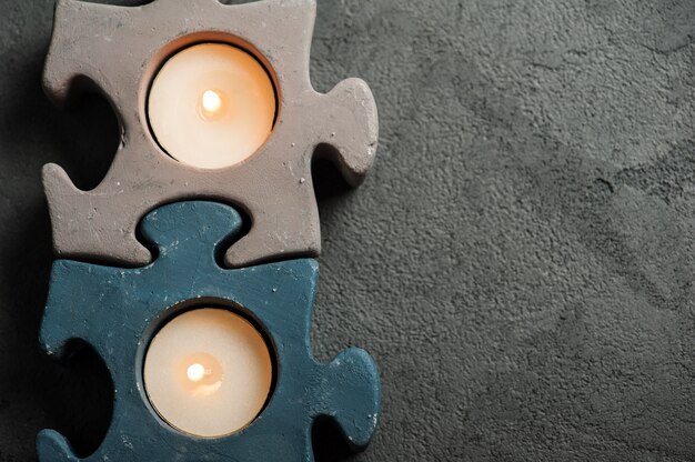 Castiçais com velas em chamas no fundo de pedra