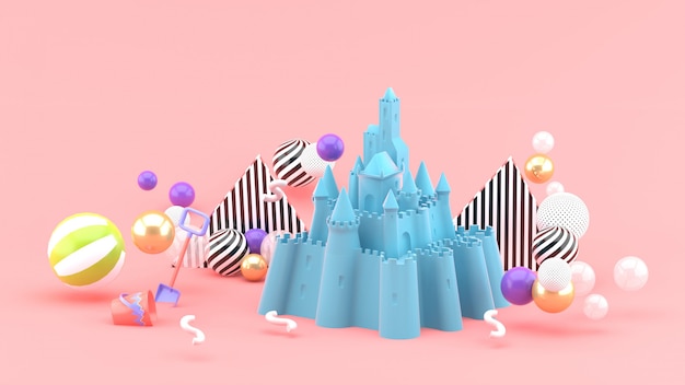 Castillo de arena azul en medio de bolas de colores en rosa. Representación 3d