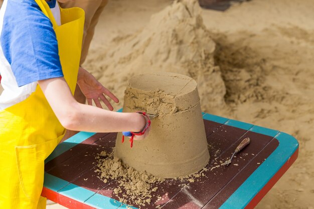 Foto castillo de arena hecho por niños en una lección de manualidades en la playa