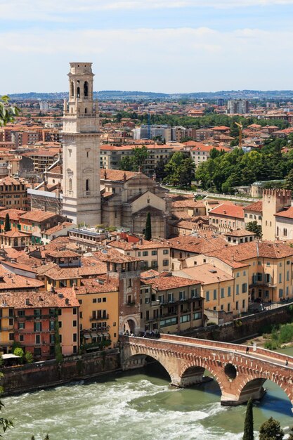 Catedral de Verona por edifícios e ponte sobre o rio
