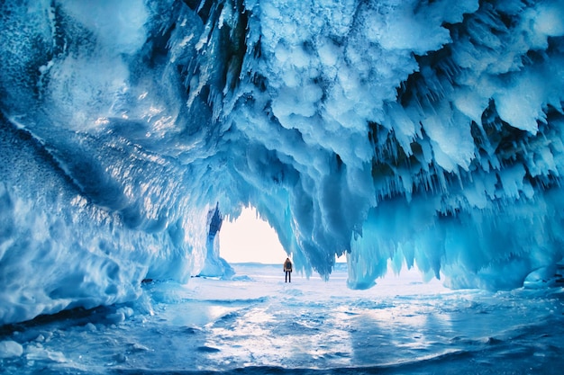 Caverna de gelo com pingentes no lago Baikal ao pôr do sol Paisagem de inverno do lago Baikal Sibéria Rússia