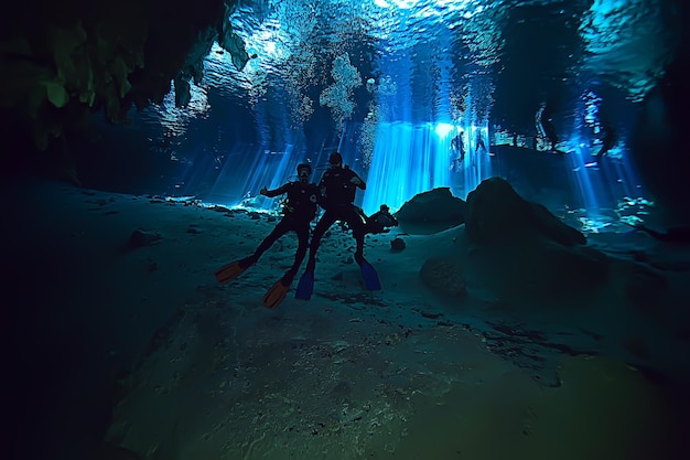 caverna mundial subaquática do cenote de Yucatan, paisagem escura de estalactites no subsolo, mergulhador