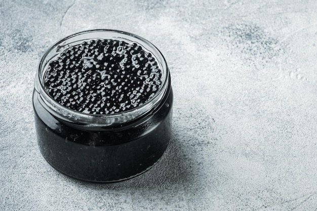 Caviar de esturión negro sobre fondo gris con espacio para copiar texto