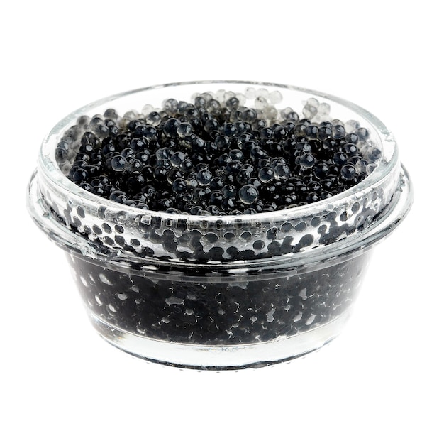 Caviar negro en un frasco de vidrio sobre un fondo blanco.