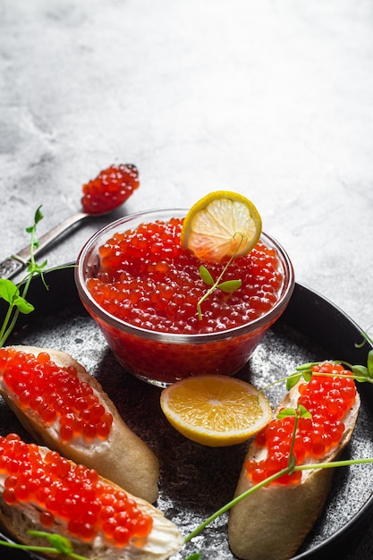 Caviar rojo sobre un fondo oscuro Sándwiches con caviar