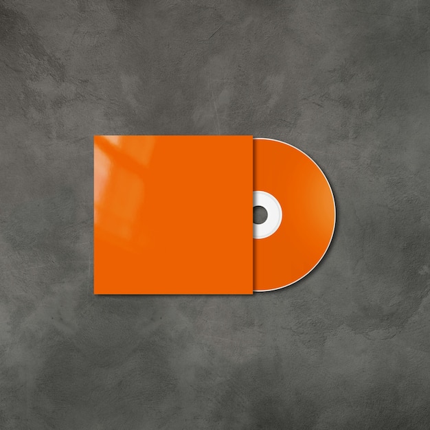 Foto cd laranja - rótulo de dvd e modelo de maquete de capa isolado no fundo de concreto