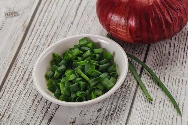 Foto cebola verde cortada em pedaços na tigela