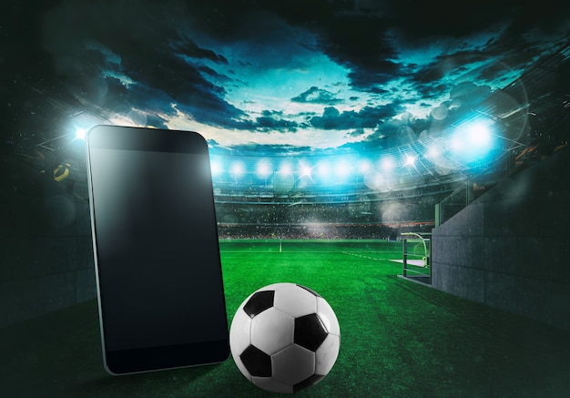 Celular e bola com um estádio de futebol ao fundo