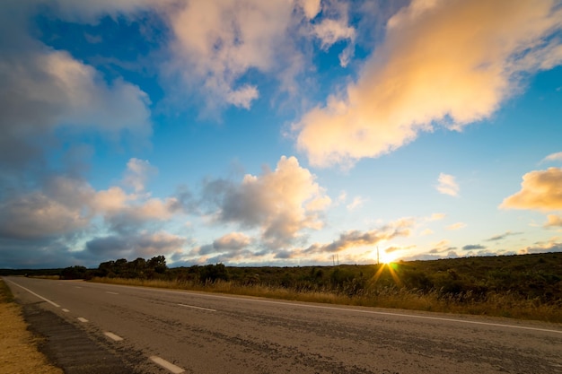 Cena de paisagem pitoresca e pôr do sol acima da estrada