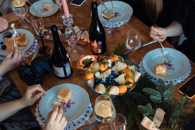 Cena navideña con velas de mandarinas y ramas de abeto para decorar