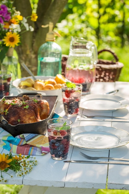 Cena con pollo y papas servida en un día soleado