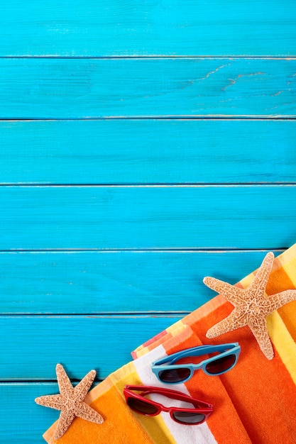 Foto cena praia, com, laranja, listrado, toalha, starfish, e, óculos de sol