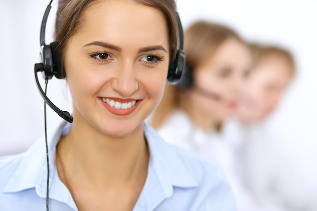 Centro de llamadas. Concéntrese en una mujer hermosa con auriculares.