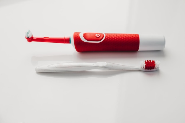 Foto cepillo de dientes eléctrico rojo sobre un fondo blanco.