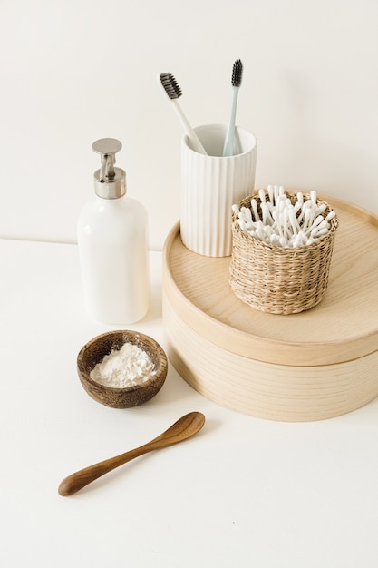 Cepillos de dientes, palillos para los oídos, crema de jabón líquido en el cuadro blanco