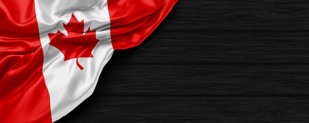 Cerca de la bandera de los Estados Unidos de Canadá en el fondo de madera negra 3D Render