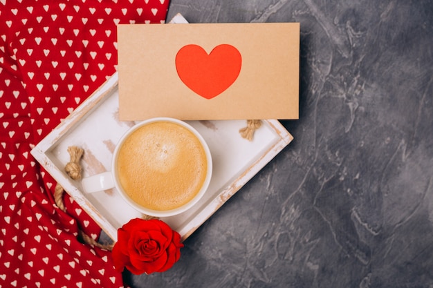 De cerca. concepto de san valentín café de la mañana, sobre con corazón, rosas en el escritorio gris. espacio libre. espacio para texto.