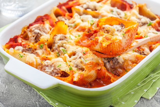 Cerca de conchas de pasta rellena al horno