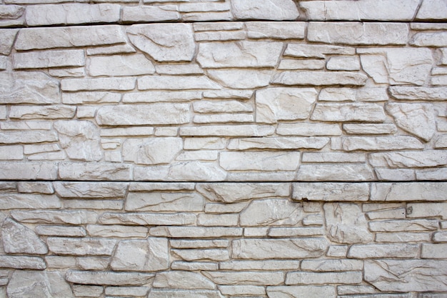 Foto cerca de pedra ornamental, fundo de raio estilizado em uma pedra selvagem natural