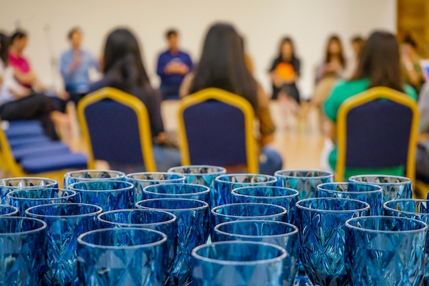 Cerca de las gafas azules de lujo dispuestas detrás del evento del taller del seminario Se preparan gafas para el público y los oradores en el taller del grupo circular