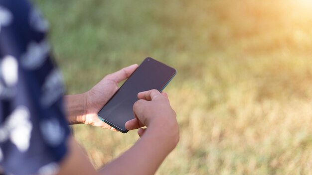 Cerca de un hombre que usa el teléfono móvil inteligente al aire libre