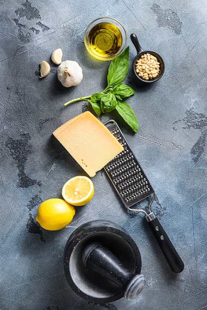 Cerca de ingredientes para pesto: albahaca, parmesano y limón.