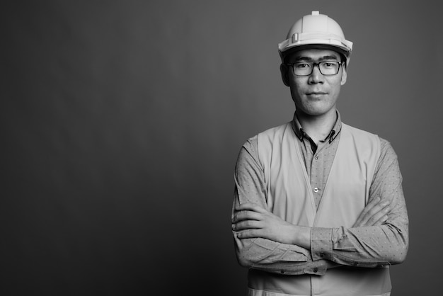 Cerca de joven asiático trabajador de la construcción con anteojos
