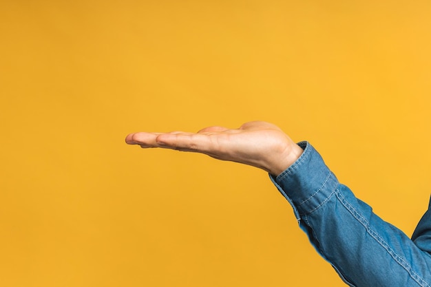 Cerca de la mano con hoding algo aislado sobre fondo amarillo