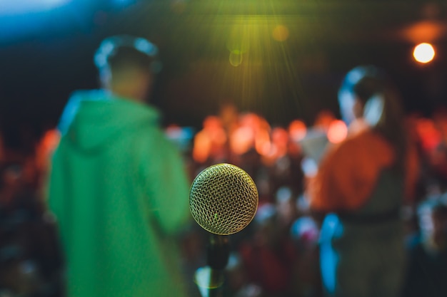 Cerca del micrófono en la sala de conciertos o sala de conferencias.