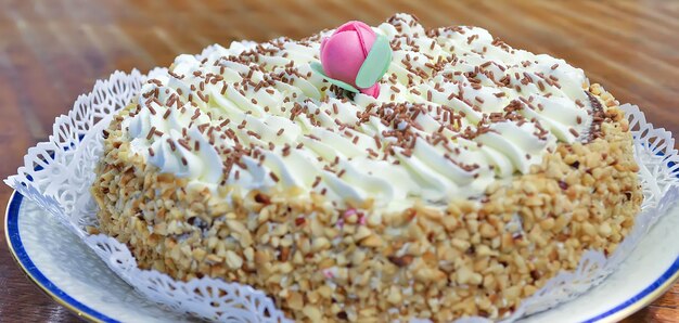 Cerca de un pastel de chantilly con una flor decorativa