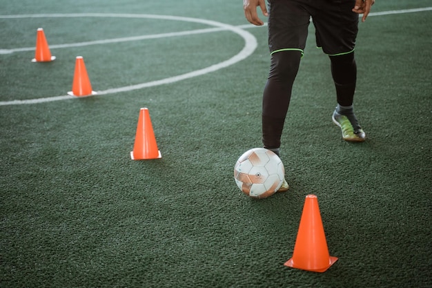 Foto cerca de los pies de un jugador de fútbol sala botando el balón