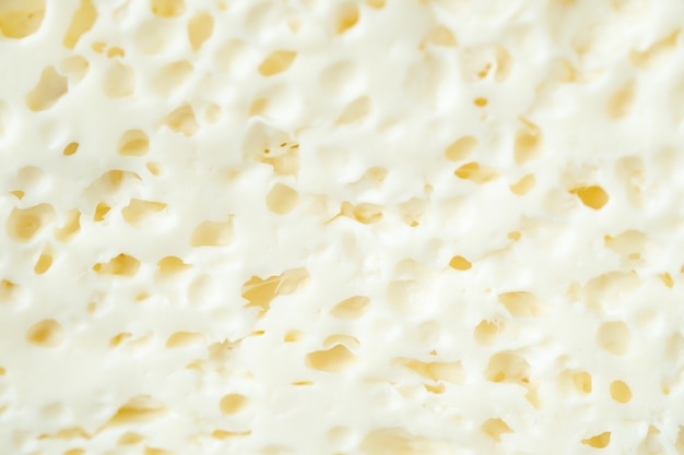 Cerca de queso fresco sobre fondo blanco.