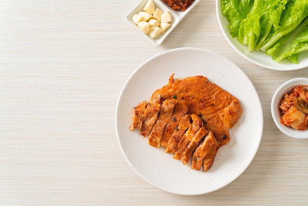 cerdo a la parrilla en salsa Kochujang marinada al estilo coreano con vegetales y kimchi - estilo de comida coreana