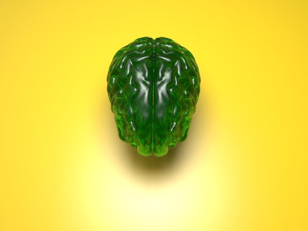 Foto cerebro de cristal verde sobre superficie amarilla