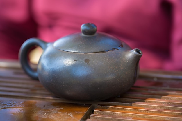 Ceremonia del té chino Tetera de cerámica hecha de arcilla y tazones sobre un fondo de madera