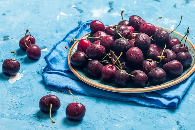 Cerezas en un bol con gotas de agua