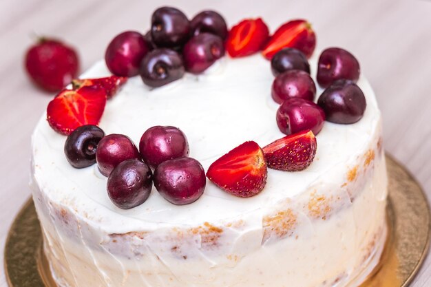 Foto cerezas y fresas encima del pastel de queso con coco