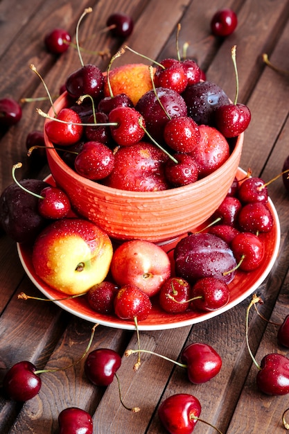 Cerezas y nectarinas frescas en la mesa de madera.